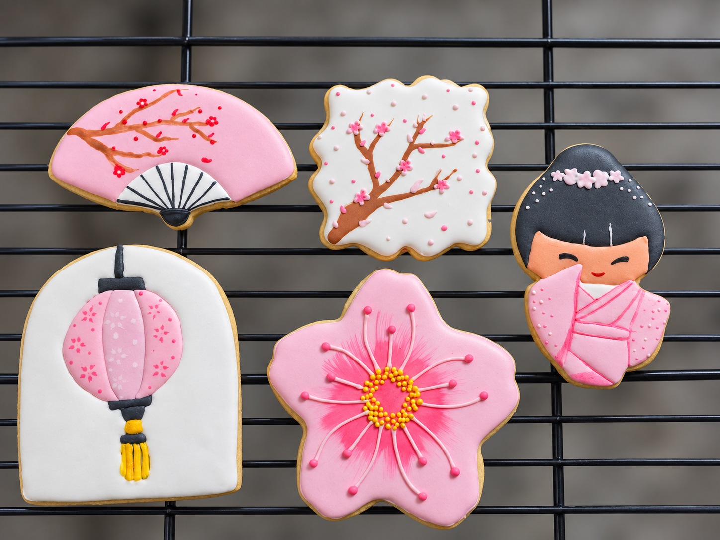 Decorated cookies featuring blossoms, a fan, and a lantern
