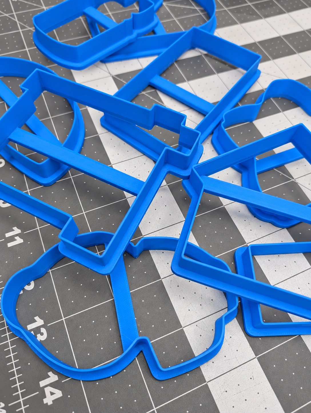 Blue custom cookie cutters printed in a range of shapes